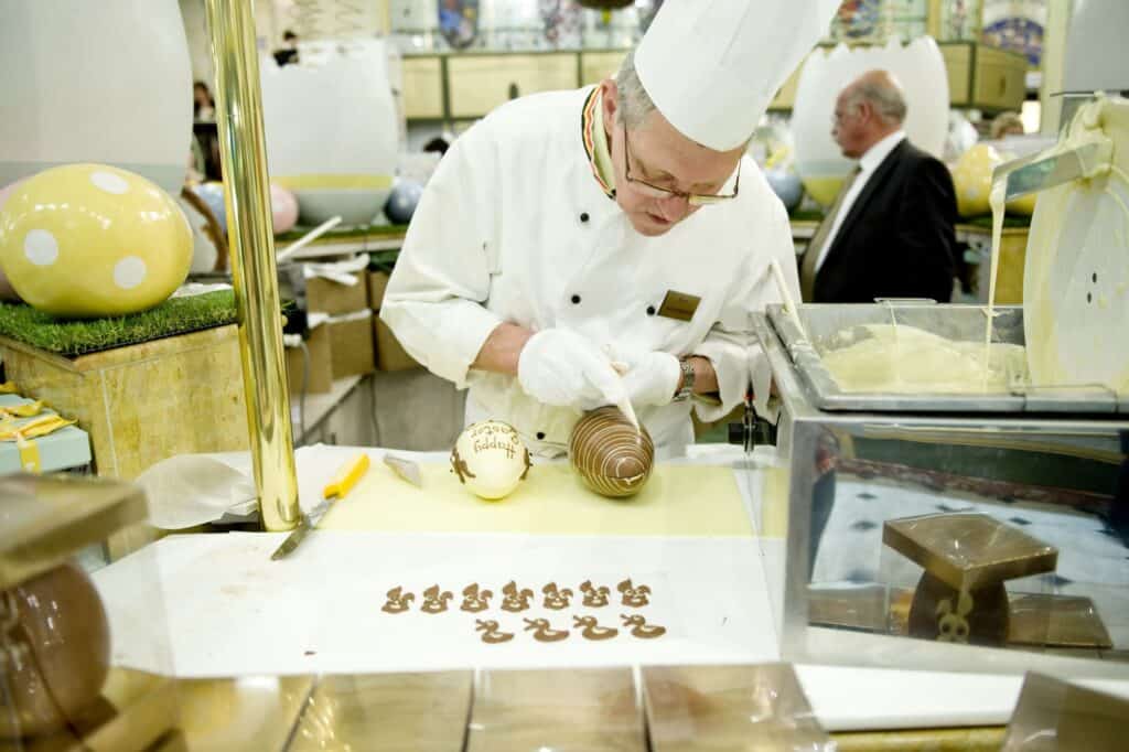 A confectioner decorating an Easter Egg chocolate candy