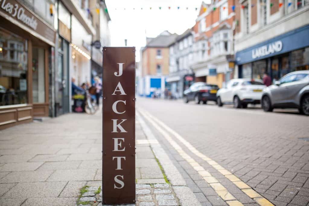 Different shops on the empty tiled sidewalk