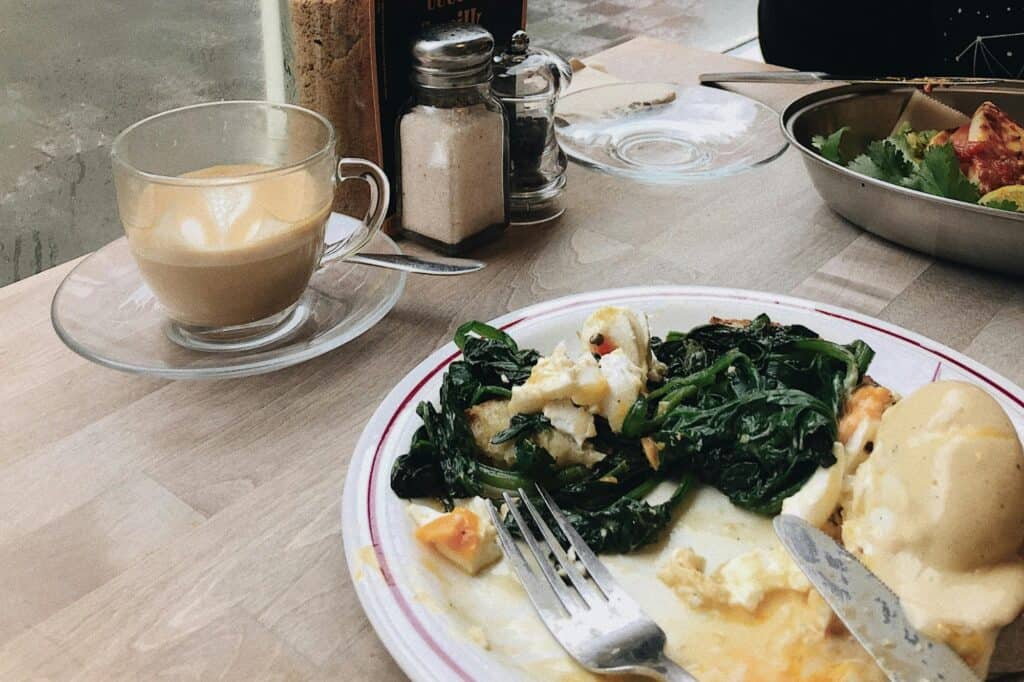 Half-finished food and latte at the table in a restaurant