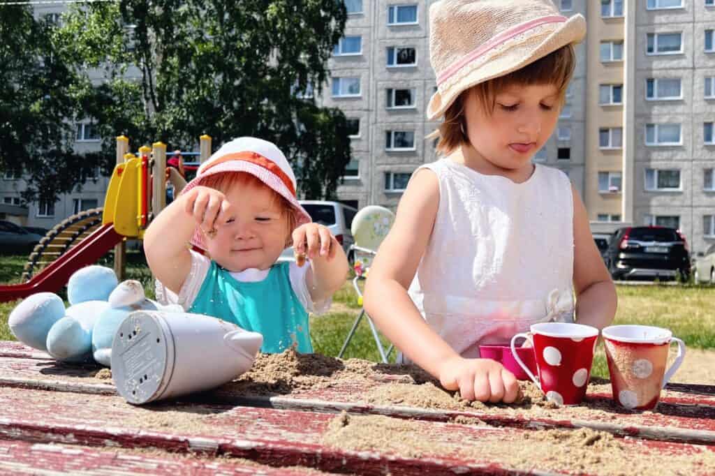 Two girls playing at the playground of the block of flats