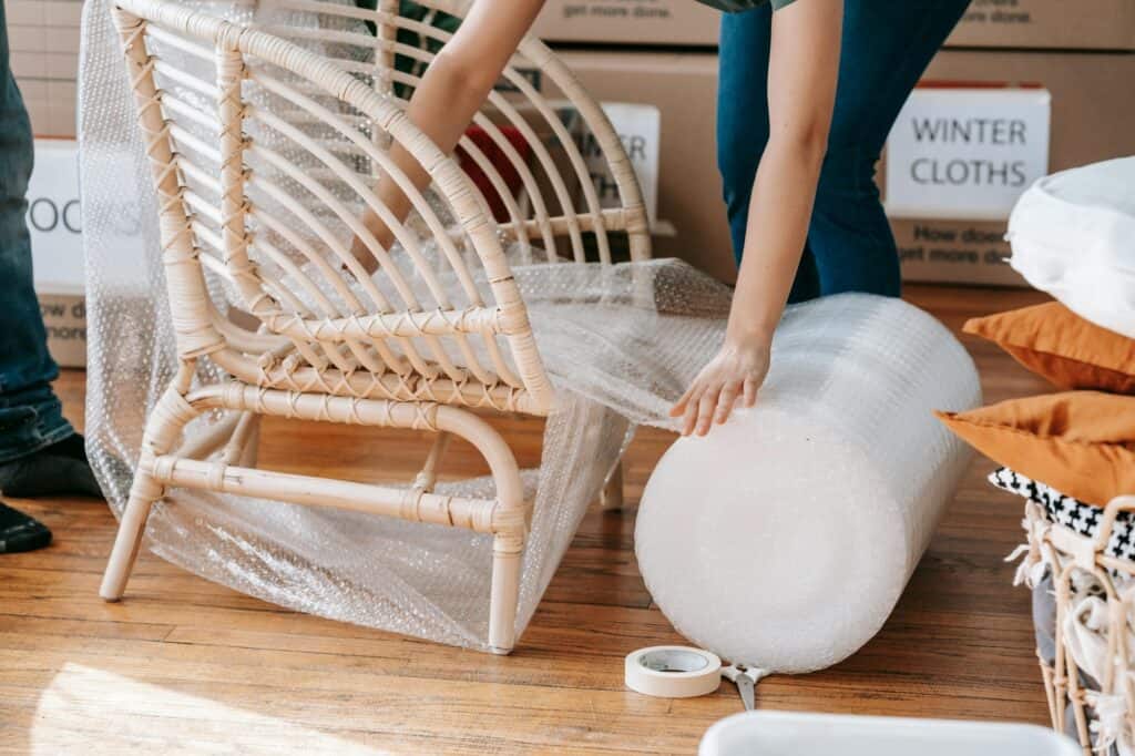 A professional mover packing a chair during the moving day